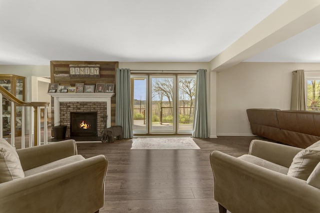 175 Templar Ave, Pinckney, MI 48169 - living area featuring baseboards, wood finished floors, and a brick fireplace