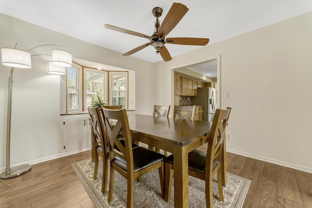 175 Templar Ave, Pinckney, MI 48169 - dining space with light wood-style floors, a ceiling fan, and baseboards