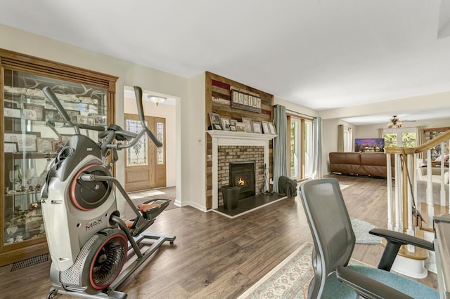 175 Templar Ave, Pinckney, MI 48169 - exercise area with wood finished floors, a fireplace, and baseboards