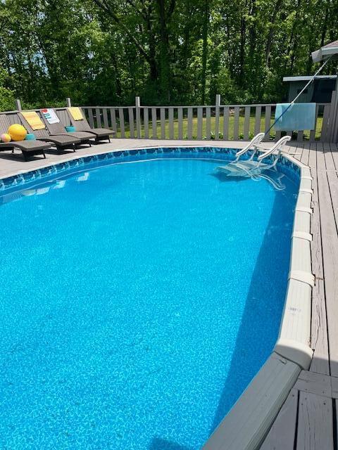 175 Templar Ave, Pinckney, MI 48169 - view of pool featuring a wooden deck and view of wooded area