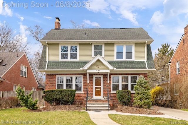 797 Washington Rd, Grosse Pointe, MI 48230 - view of front of property with a chimney, roof with shingles, and brick siding