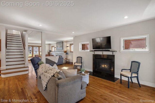 797 Washington Rd, Grosse Pointe, MI 48230 - living room with a glass covered fireplace, wood finished floors, stairway, baseboards, and recessed lighting