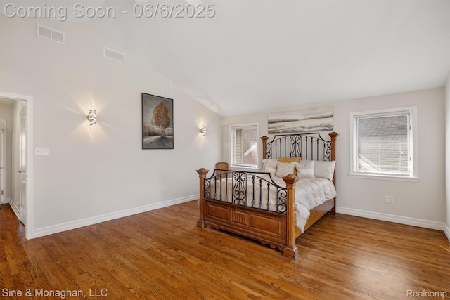 797 Washington Rd, Grosse Pointe, MI 48230 - bedroom with multiple windows, baseboards, wood finished floors, and vaulted ceiling