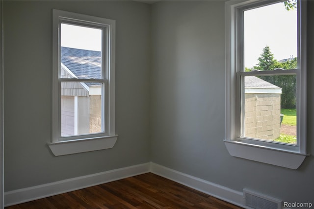 3434 Durham Rd, Clawson, MI 48073 - empty room featuring baseboards, plenty of natural light, and dark wood-style floors