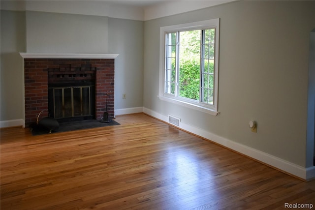 3434 Durham Rd, Clawson, MI 48073 - unfurnished living room featuring wood finished floors, baseboards, and a fireplace