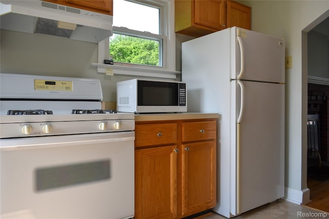 3434 Durham Rd, Clawson, MI 48073 - kitchen with white appliances, under cabinet range hood, brown cabinets, and light countertops