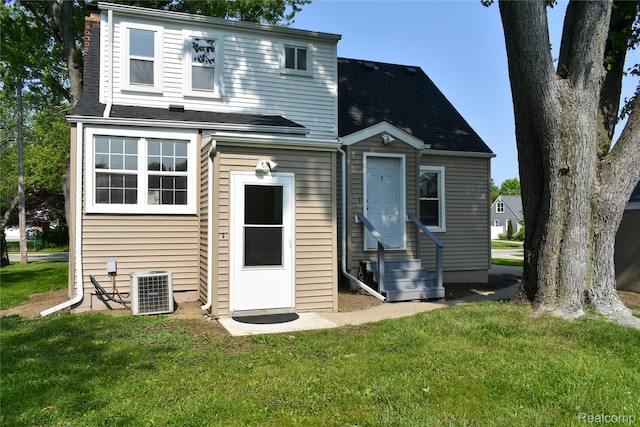 3434 Durham Rd, Clawson, MI 48073 - back of house featuring central air condition unit, a yard, entry steps, and a shingled roof
