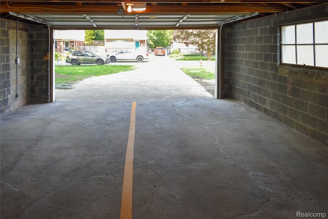 3434 Durham Rd, Clawson, MI 48073 - garage with a garage door opener and concrete block wall
