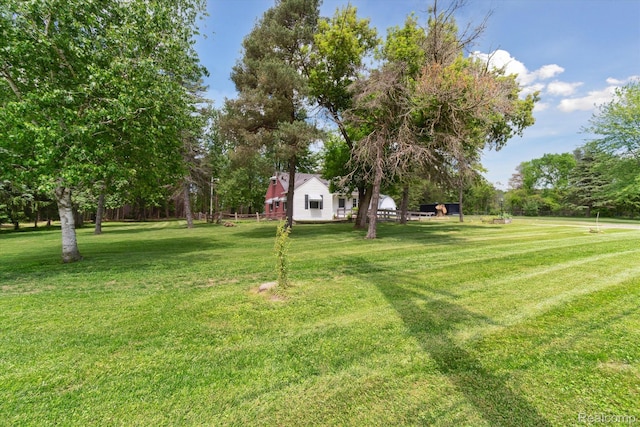 1250 W Thompson Rd, Fenton, MI 48430 - view of green lawn featuring view of wooded area