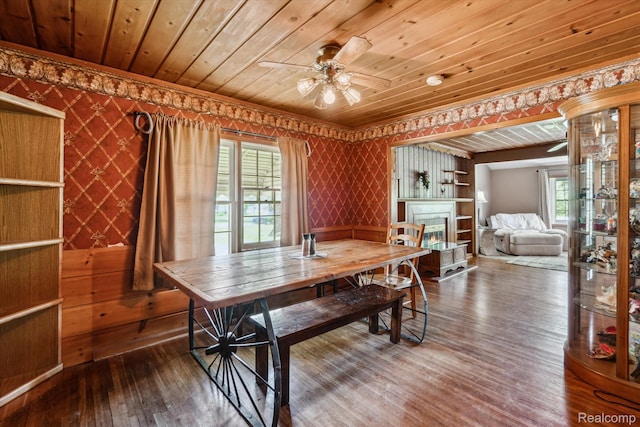 1250 W Thompson Rd, Fenton, MI 48430 - dining space featuring wallpapered walls, wooden ceiling, ceiling fan, wood-type flooring, and crown molding