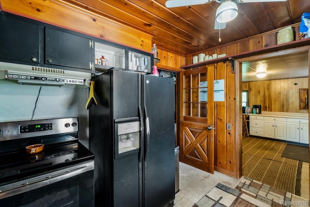1250 W Thompson Rd, Fenton, MI 48430 - kitchen with black fridge with ice dispenser, stainless steel electric stove, under cabinet range hood, wood walls, and a ceiling fan