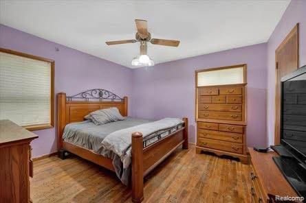 4131 Wellman Line Rd, Brown City, MI 48416 - bedroom featuring wood finished floors, baseboards, and ceiling fan