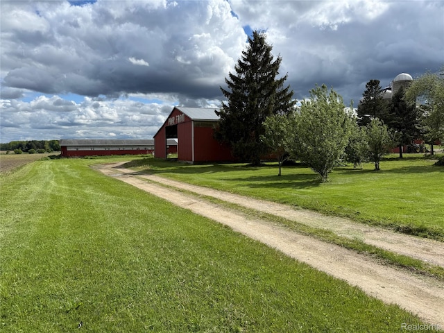4131 Wellman Line Rd, Brown City, MI 48416 - view of grassy yard featuring an outbuilding, a pole building, and driveway
