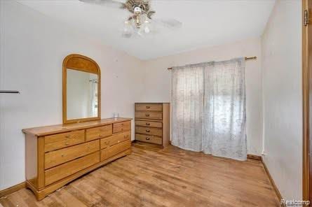 4131 Wellman Line Rd, Brown City, MI 48416 - bedroom featuring light wood-type flooring, ceiling fan, and baseboards