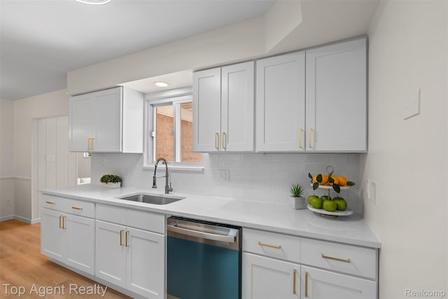 32532 Steinhauer St, Westland, MI 48186 - kitchen featuring dishwasher, a sink, light countertops, white cabinets, and decorative backsplash