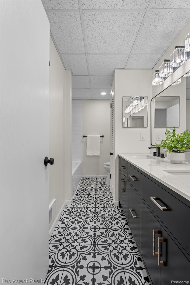 32532 Steinhauer St, Westland, MI 48186 - full bathroom featuring double vanity, toilet, a drop ceiling, baseboards, and a tub to relax in