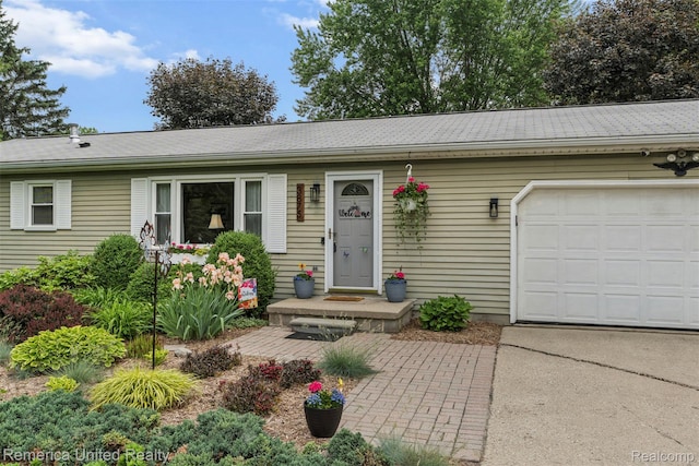 3875 Zimmer Rd, Williamston, MI 48895 - ranch-style house with an attached garage, driveway, and a shingled roof