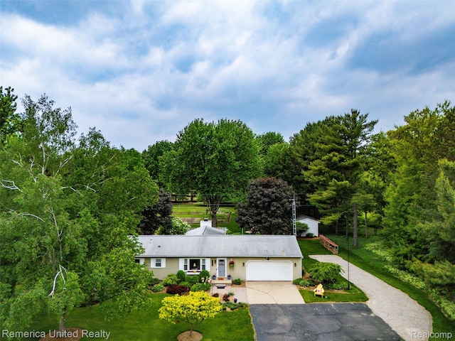 3875 Zimmer Rd, Williamston, MI 48895 - single story home with a garage, driveway, and a front yard
