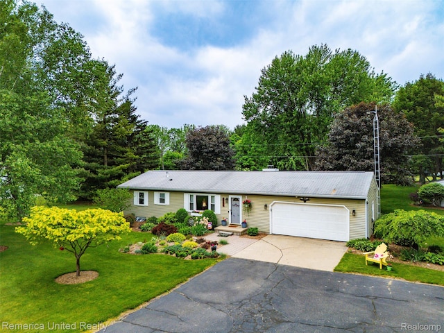 3875 Zimmer Rd, Williamston, MI 48895 - ranch-style home featuring driveway, an attached garage, and a front lawn