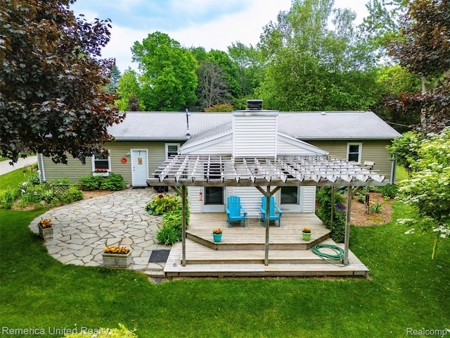 3875 Zimmer Rd, Williamston, MI 48895 - rear view of house with a deck, a lawn, and a chimney
