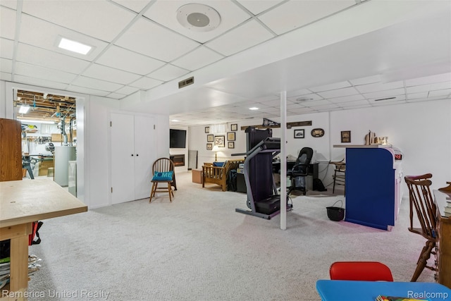 3875 Zimmer Rd, Williamston, MI 48895 - exercise room with a paneled ceiling, carpet, and water heater