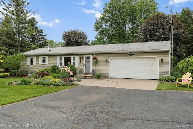 3875 Zimmer Rd, Williamston, MI 48895 - ranch-style house with asphalt driveway, an attached garage, and a front yard