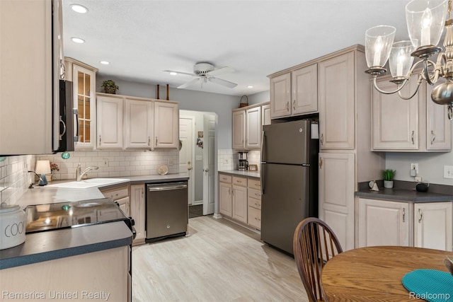 3875 Zimmer Rd, Williamston, MI 48895 - kitchen with stainless steel appliances, a ceiling fan, decorative backsplash, recessed lighting, and a chandelier