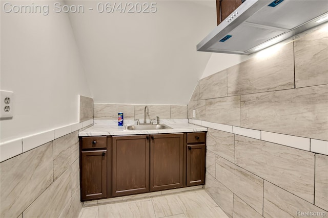 3851 Fredro St, Hamtramck, MI 48212 - bathroom featuring tile walls, vanity, vaulted ceiling, and a wainscoted wall