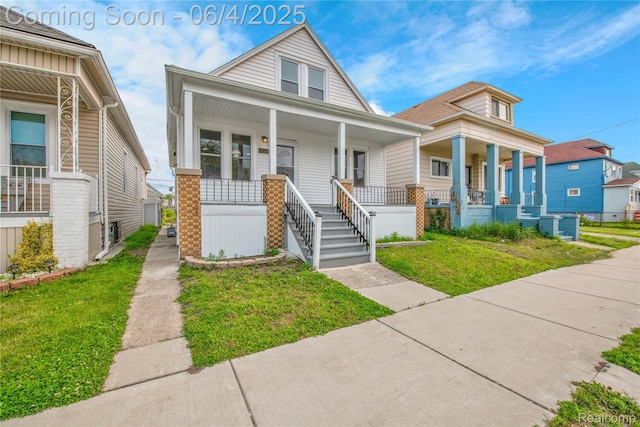 3851 Fredro St, Hamtramck, MI 48212 - view of front of property with covered porch and a front yard