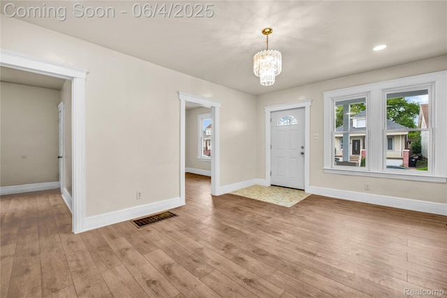 3851 Fredro St, Hamtramck, MI 48212 - entrance foyer with a chandelier, baseboards, and light wood-style floors