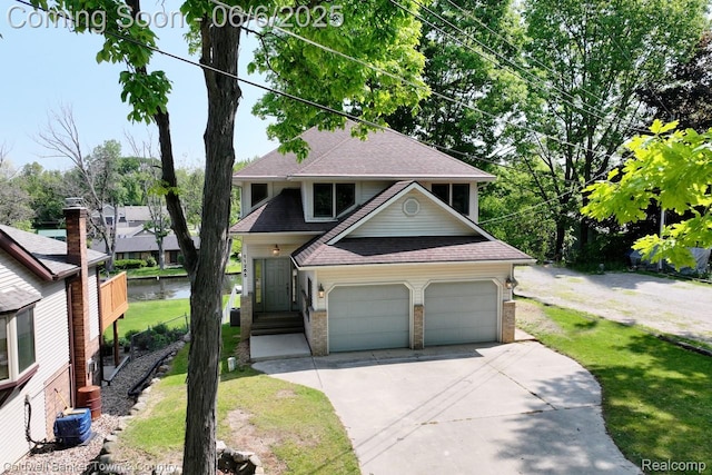 11265 N Shore Dr, Whitmore Lake, MI 48189 - view of front of home with driveway, roof with shingles, brick siding, and a front lawn