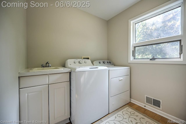 11265 N Shore Dr, Whitmore Lake, MI 48189 - laundry area featuring independent washer and dryer, light wood-style floors, baseboards, and cabinet space