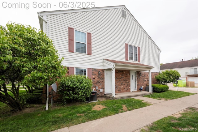35485 Stillmeadow Ln, Clinton Township, MI 48035 - view of property with brick siding, central air condition unit, and a front yard