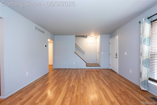 35485 Stillmeadow Ln, Clinton Township, MI 48035 - empty room with light wood-style floors, stairway, and baseboards