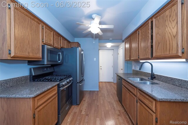 35485 Stillmeadow Ln, Clinton Township, MI 48035 - kitchen with appliances with stainless steel finishes, a sink, light wood-type flooring, ceiling fan, and brown cabinetry