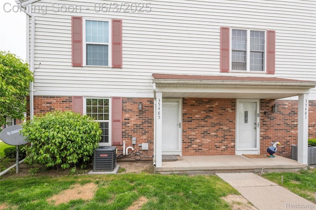 35485 Stillmeadow Ln, Clinton Township, MI 48035 - view of front of house featuring central air condition unit and brick siding