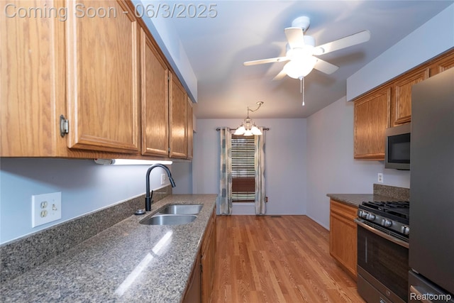 35485 Stillmeadow Ln, Clinton Township, MI 48035 - kitchen featuring stainless steel appliances, a sink, brown cabinets, ceiling fan, and light wood-style floors