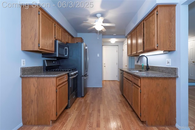 35485 Stillmeadow Ln, Clinton Township, MI 48035 - kitchen featuring stainless steel appliances, a sink, ceiling fan, light wood-style floors, and brown cabinets