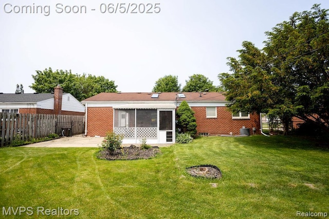 33316 Fraser Ave, Fraser, MI 48026 - rear view of property featuring brick siding, a sunroom, and a patio