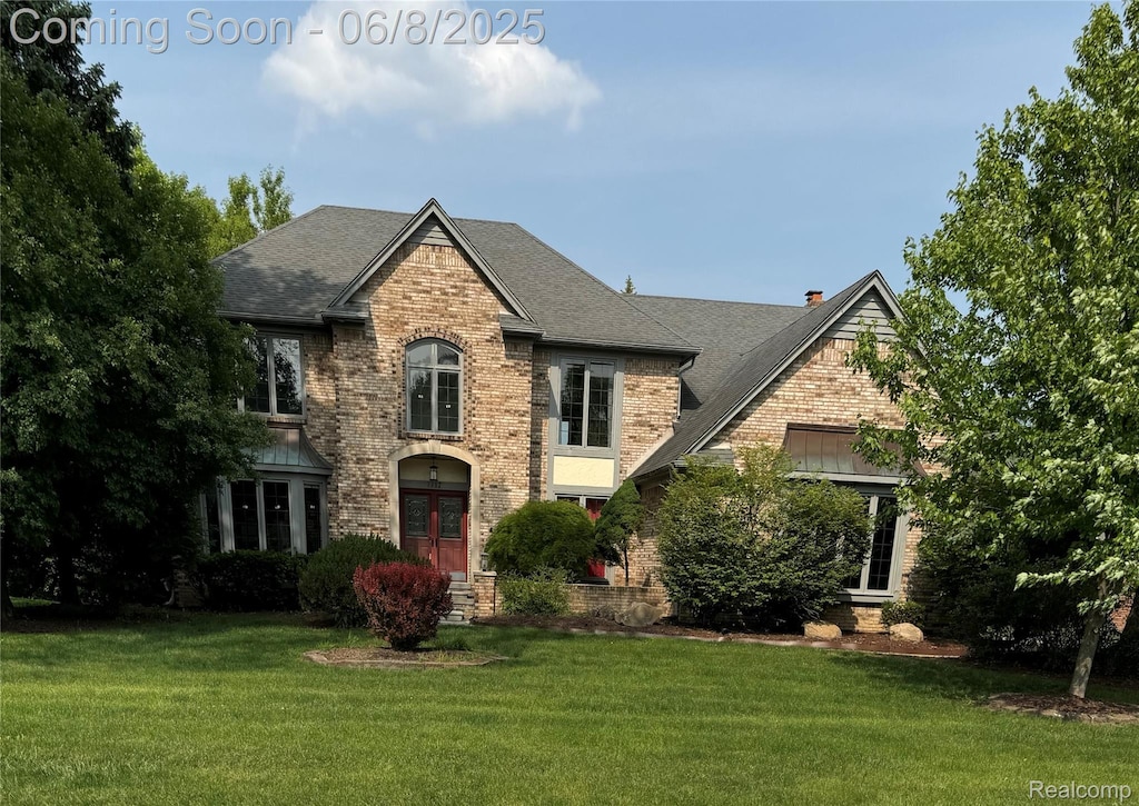 1717 Brandywine Dr, Bloomfield Hills, MI 48304 - view of front of house with brick siding, a front lawn, and roof with shingles