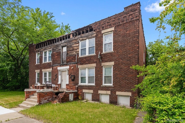 3804 Hudson St, Detroit, MI 48208 - view of front of property featuring brick siding and a front lawn