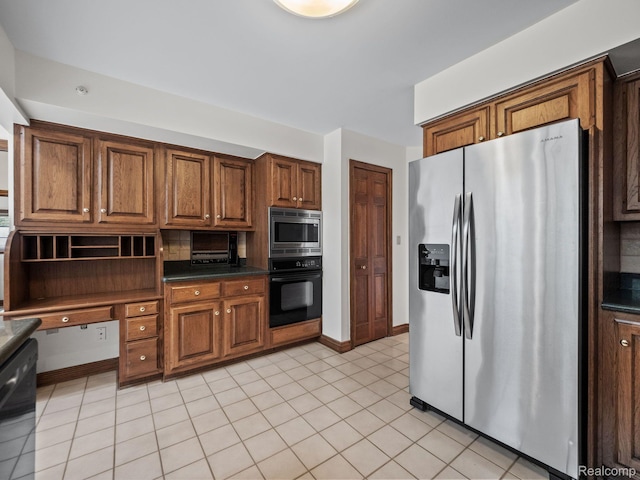 4932 Susans Way, Bloomfield Hills, MI 48302 - kitchen featuring appliances with stainless steel finishes, dark countertops, brown cabinets, and baseboards
