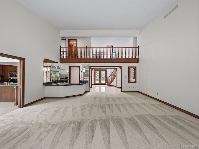 4932 Susans Way, Bloomfield Hills, MI 48302 - unfurnished living room with carpet flooring, a high ceiling, baseboards, and french doors
