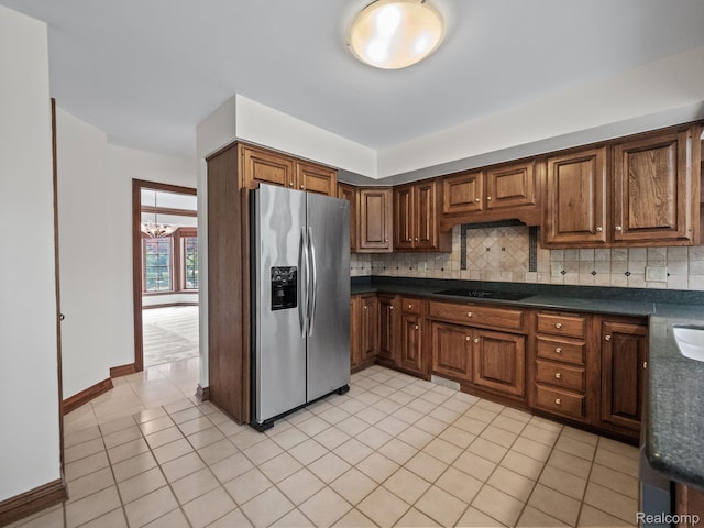 4932 Susans Way, Bloomfield Hills, MI 48302 - kitchen featuring stainless steel fridge, dark countertops, a chandelier, black electric cooktop, and backsplash