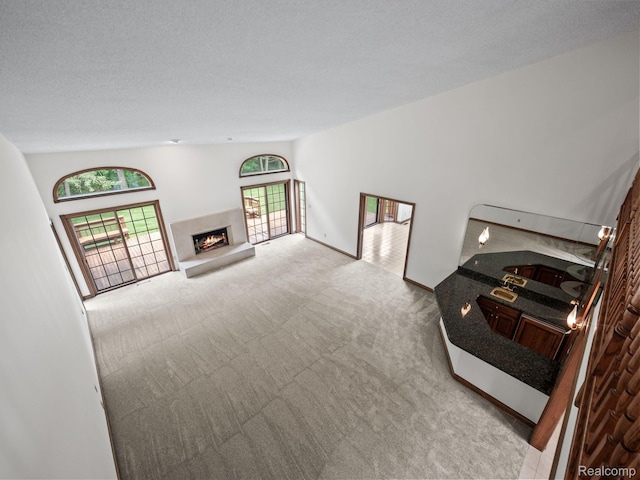 4932 Susans Way, Bloomfield Hills, MI 48302 - carpeted living area with a fireplace, a textured ceiling, and baseboards