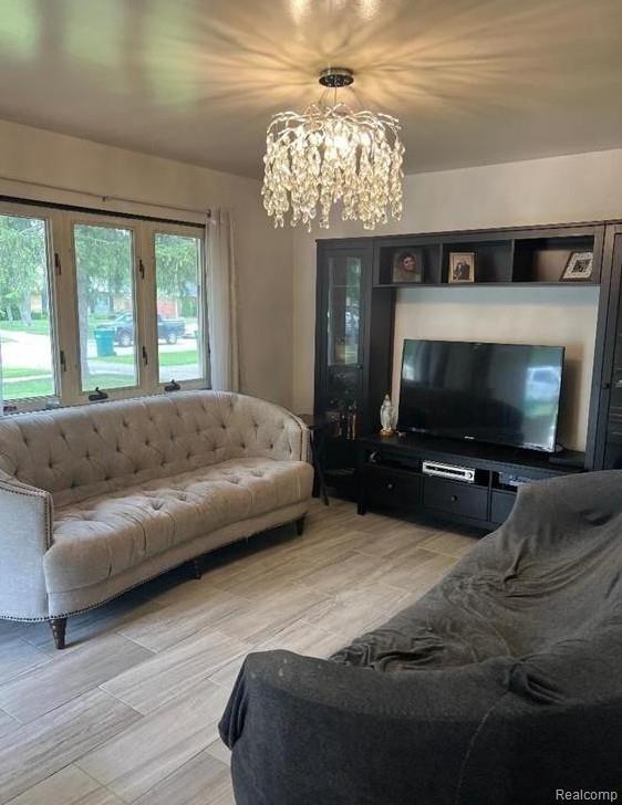 41541 Mcbride Ave, Van Buren, MI 48111 - living room featuring a chandelier and light wood-style flooring