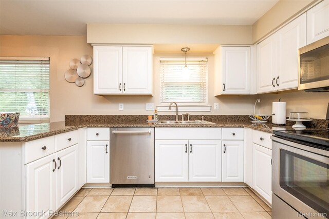 2655 Aspen Ln, Bloomfield Hills, MI 48302 - kitchen with appliances with stainless steel finishes, a sink, white cabinetry, a peninsula, and light tile patterned flooring