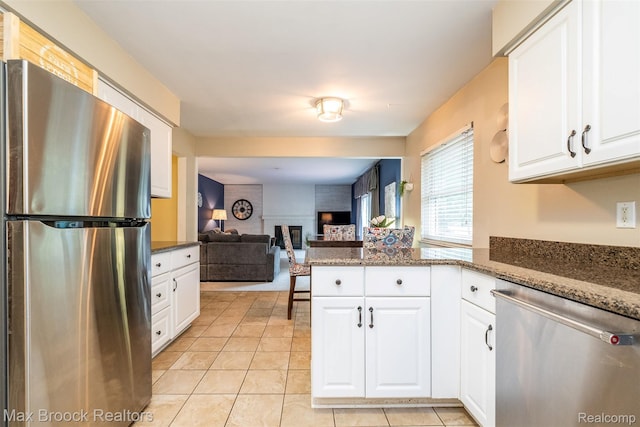 2655 Aspen Ln, Bloomfield Hills, MI 48302 - kitchen featuring stainless steel appliances, a peninsula, and white cabinetry