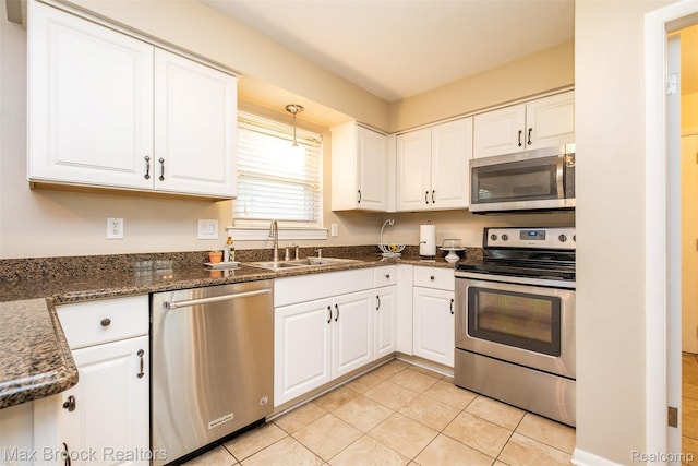 2655 Aspen Ln, Bloomfield Hills, MI 48302 - kitchen with appliances with stainless steel finishes, light tile patterned floors, white cabinetry, and a sink
