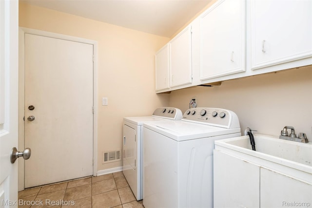 2655 Aspen Ln, Bloomfield Hills, MI 48302 - laundry room featuring cabinet space, washer and clothes dryer, and light tile patterned flooring